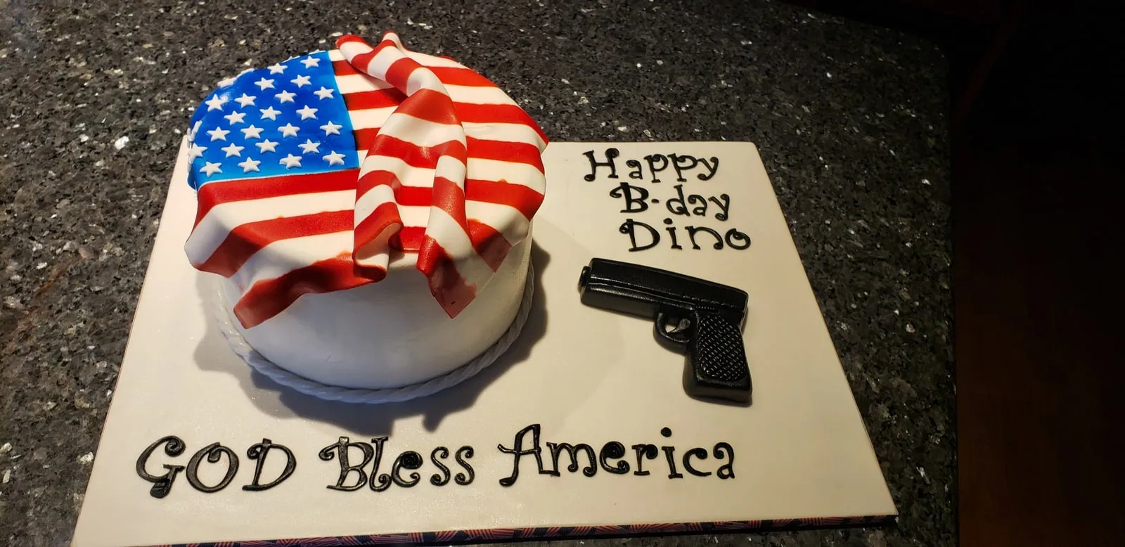 Patriotic cake with a draped fondant American flag and God Bless America plaque