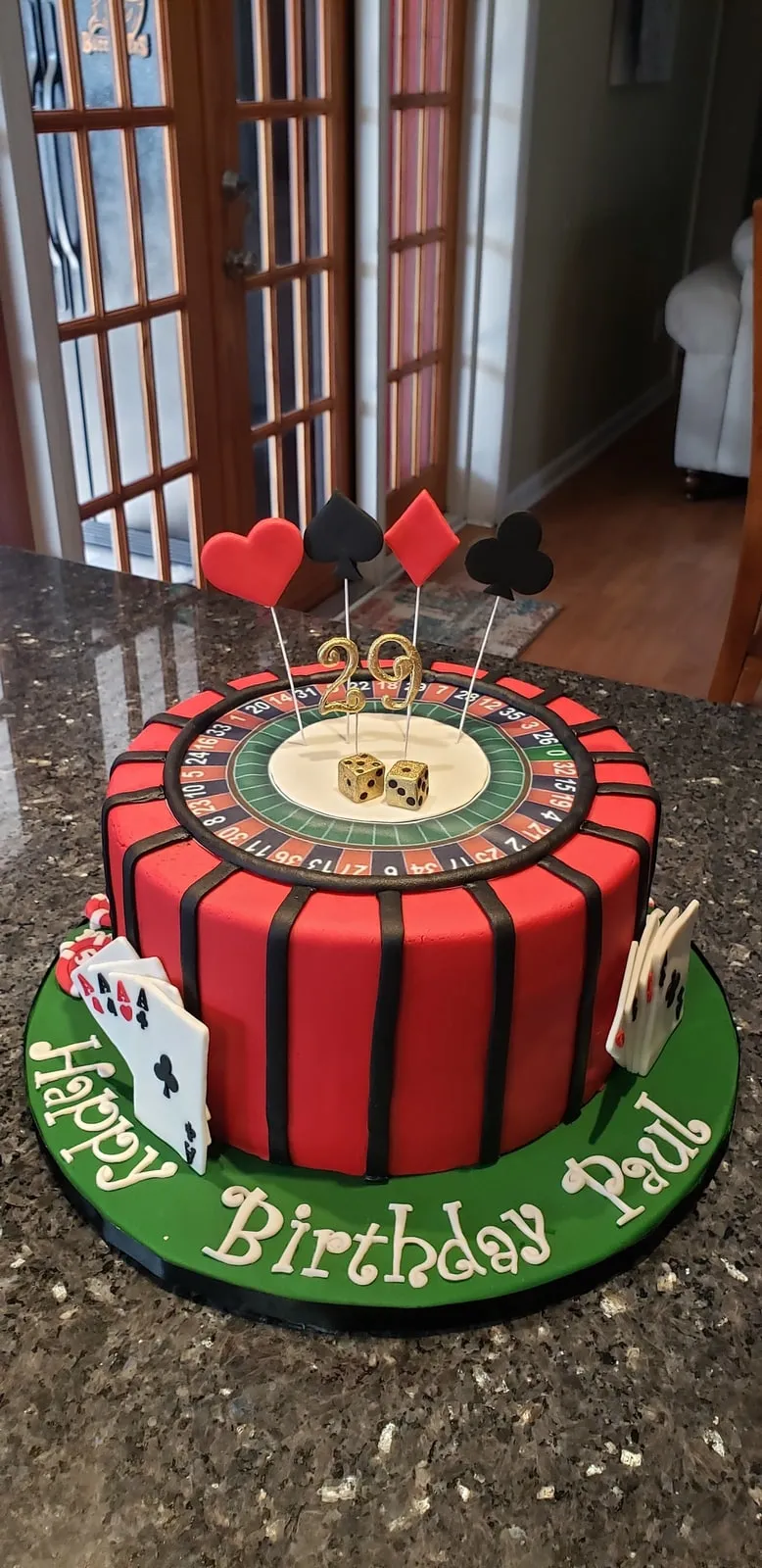 Casino themed birthday cake with fondant playing cards, dice and poker chips