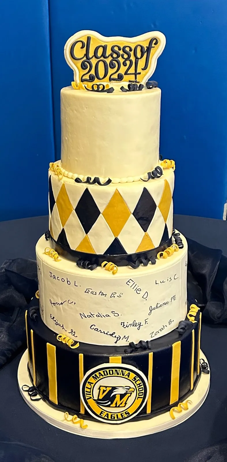 Three tier Class of 2024 graduation cake in navy, gold and harlequin print