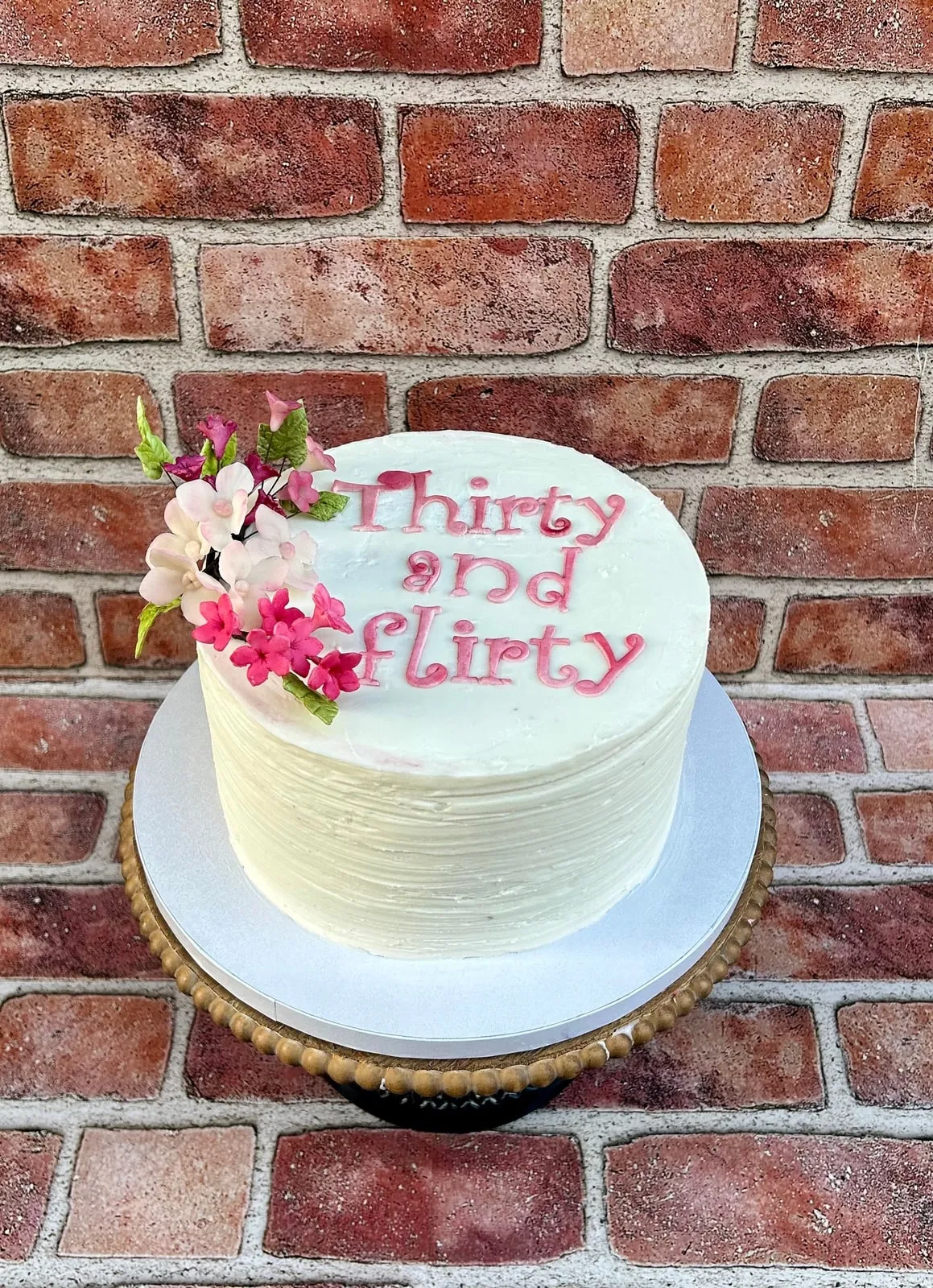 Ivory buttercream Thirty and Flirty birthday cake with sugar blossoms